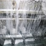 ice delivery system and rake type freezer for ice storage