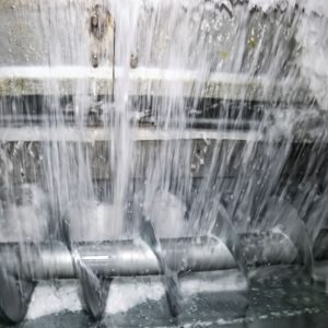 ice delivery system and rake type freezer for ice storage