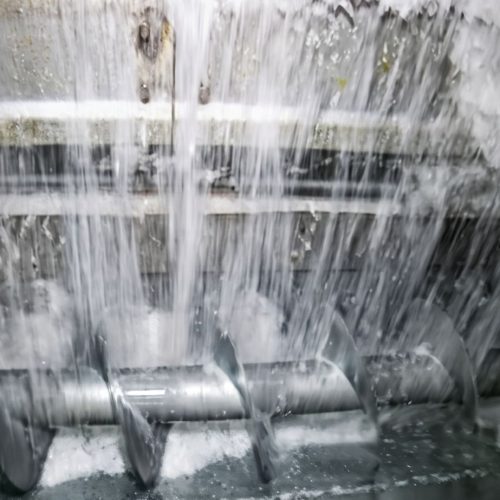 ice delivery system and rake type freezer for ice storage